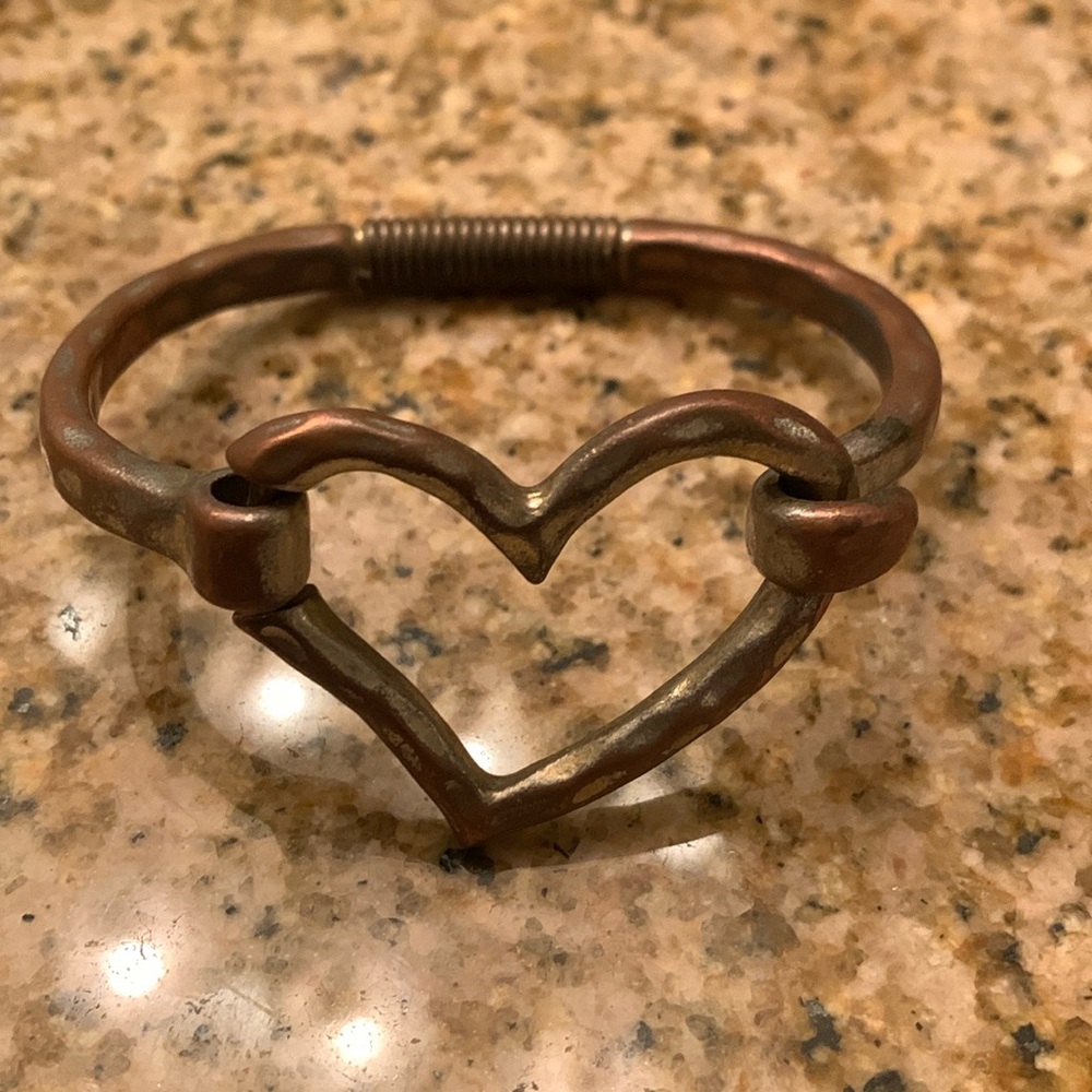 Heart shaped bangle bracelet.  Hammered metal.  Front close.